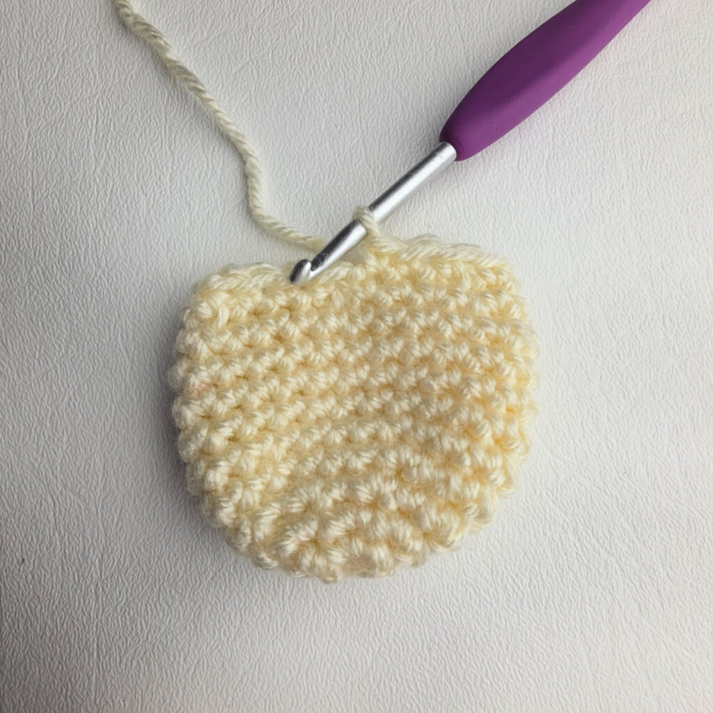 Ivory colored crochet amigurumi ornament head.