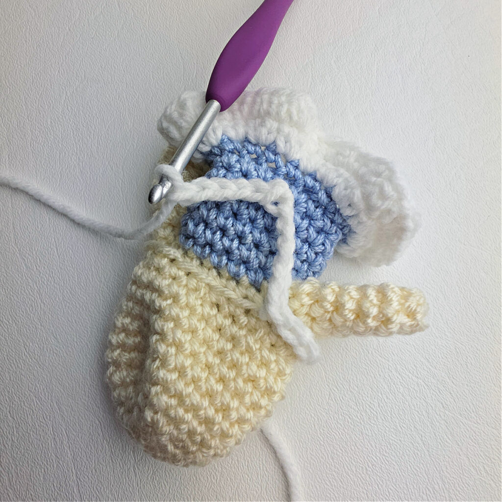 Close-up photo showing how to crochet the details on a ballerina's shoulders and front of her dress.