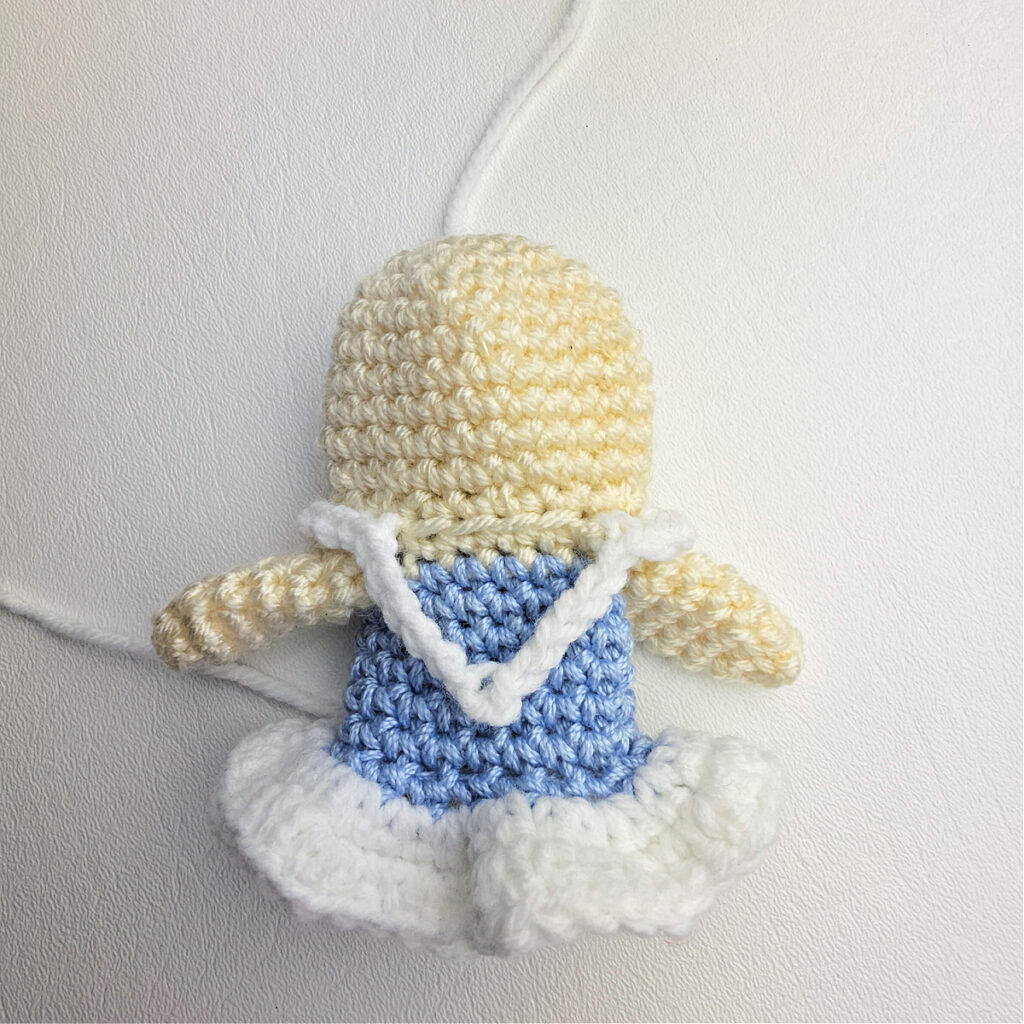 White straps and details added to the crochet ballerina's dress.