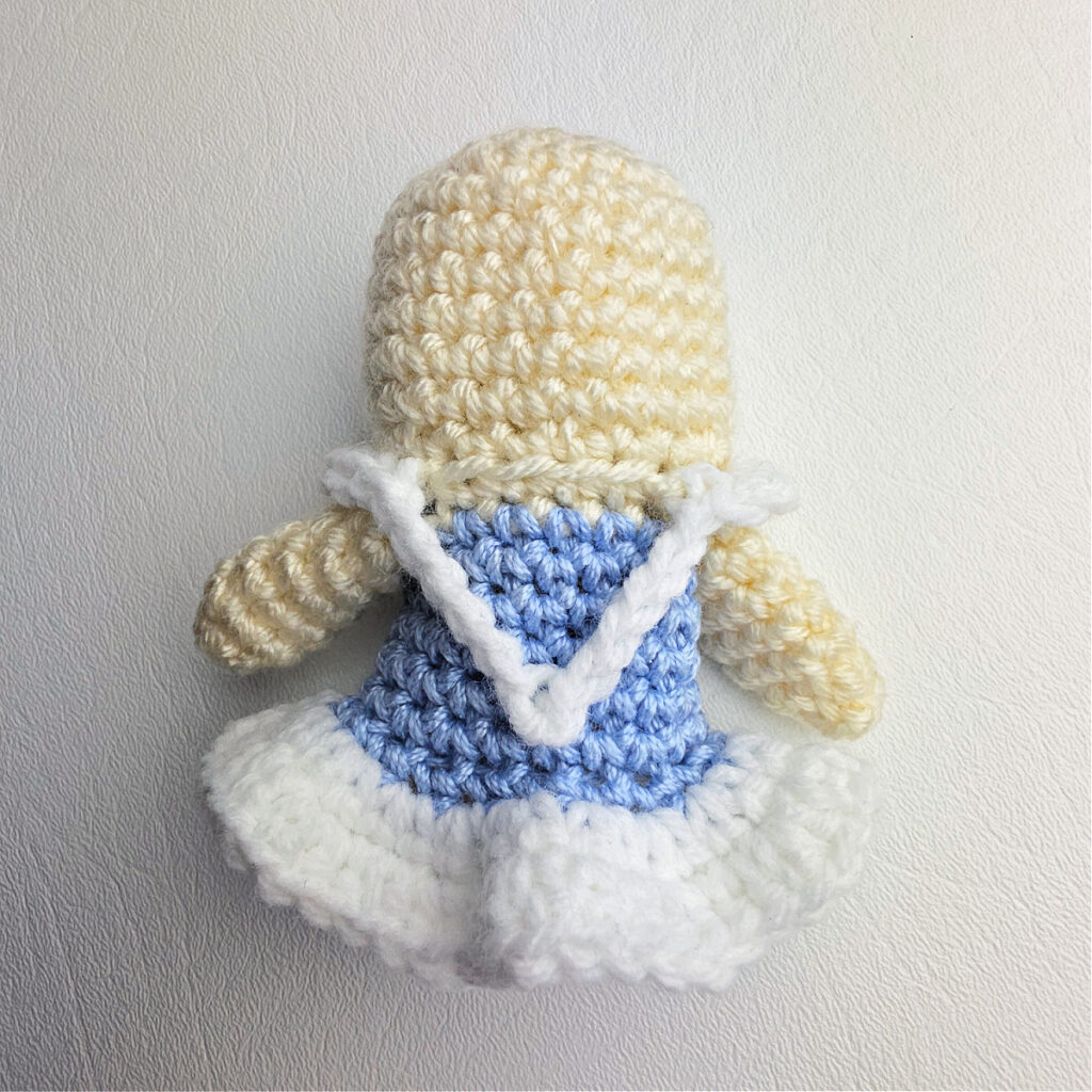 A crochet snow queen body and dress complete and ready for hair and a face.