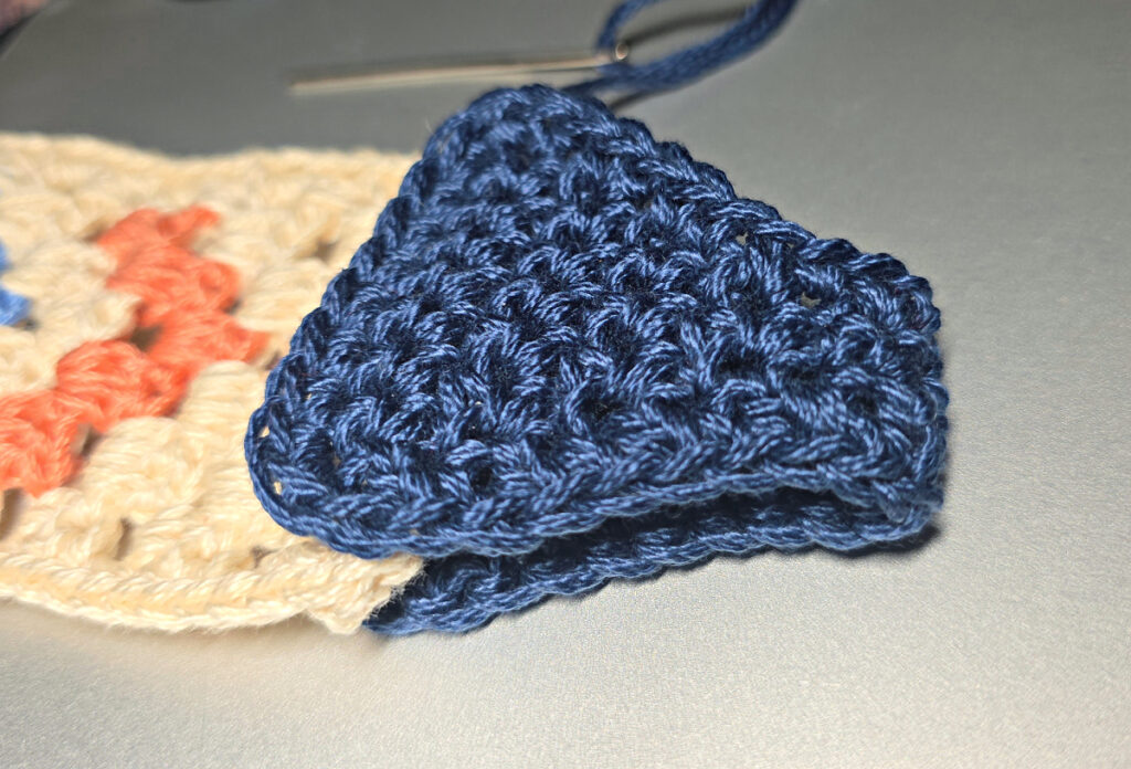 Attaching the strap connector to a crochet crossbody bag.