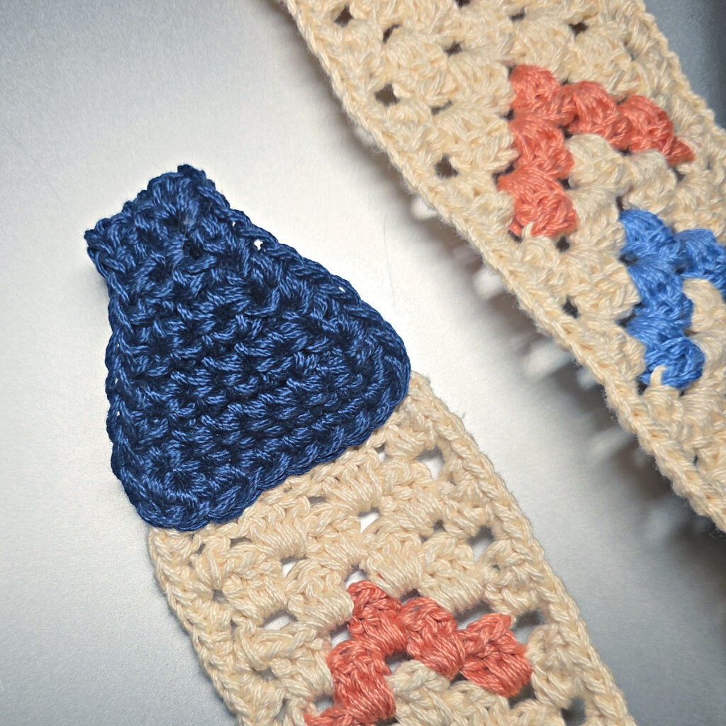 Attaching the strap connector to a crochet crossbody bag.