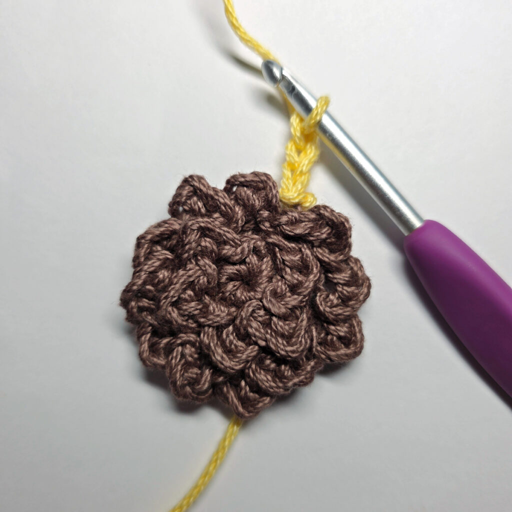 Making a crochet sunflower.