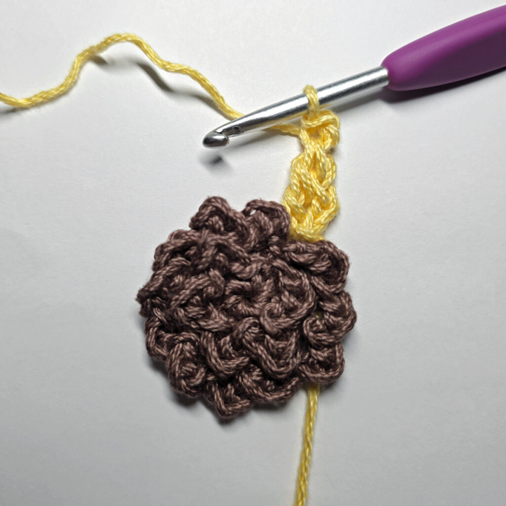 Making a crochet sunflower.