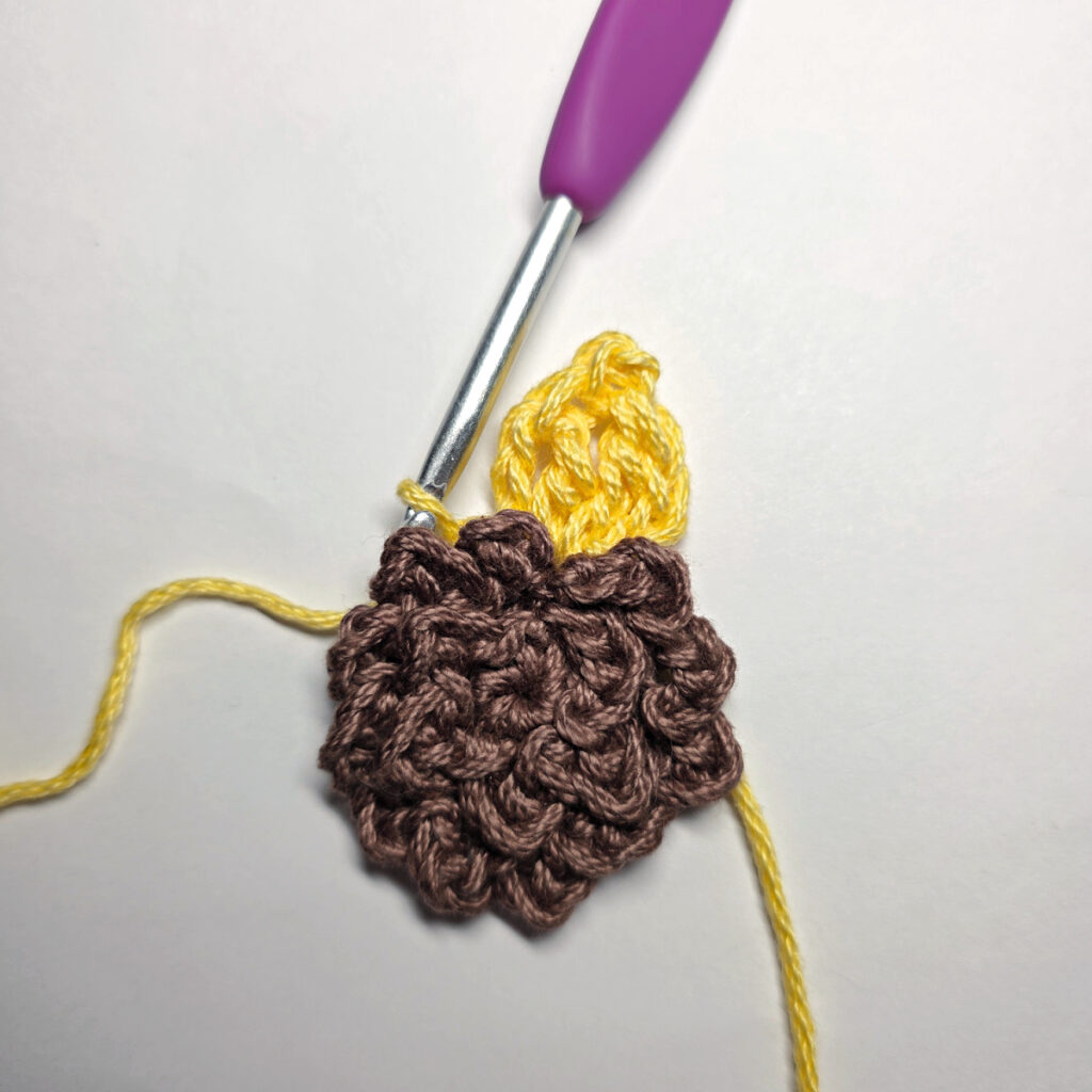 Making a crochet sunflower.