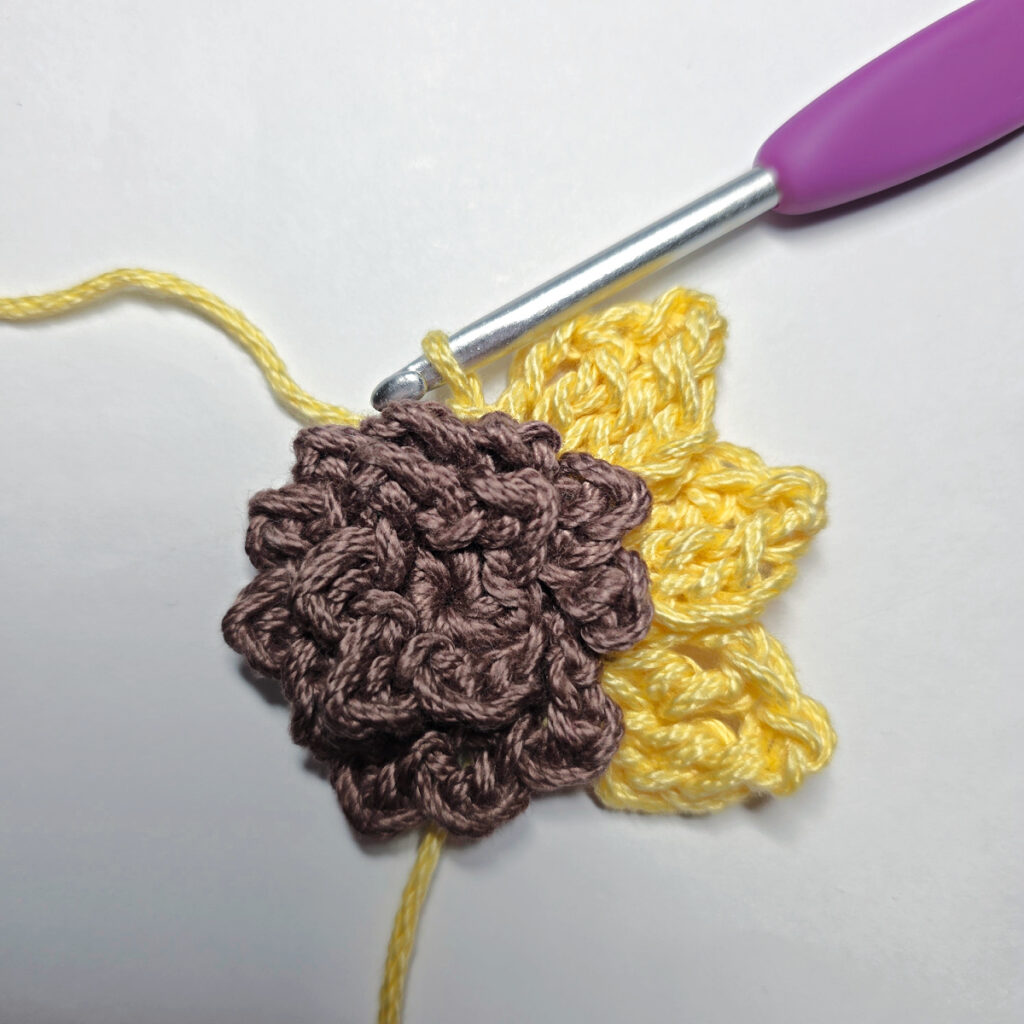Making a crochet sunflower.