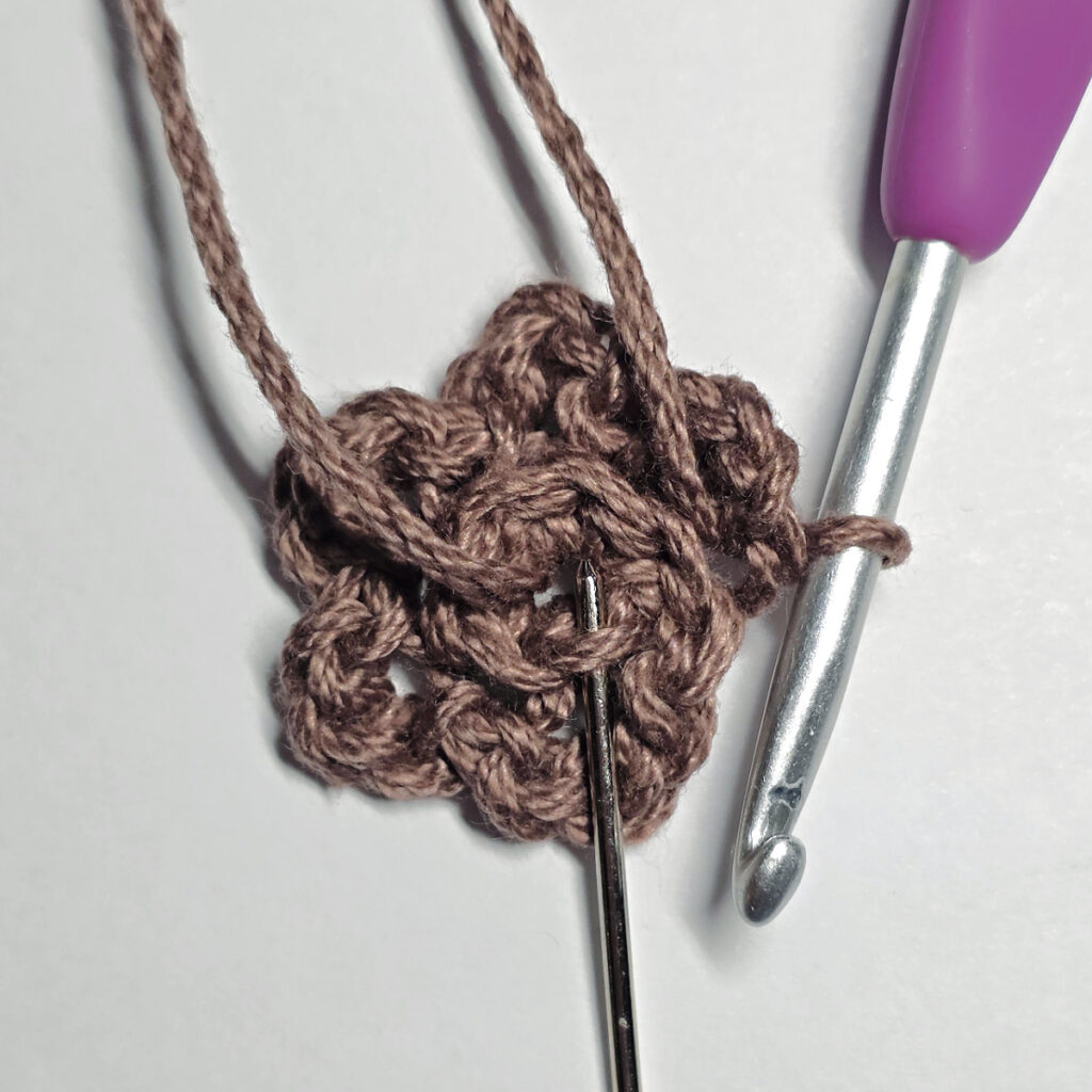 Making a crochet sunflower.