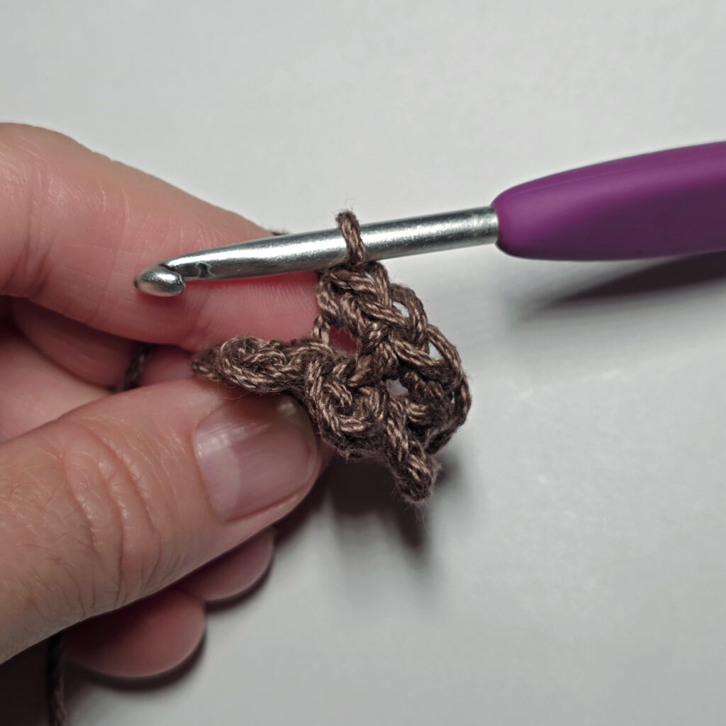 Making a crochet sunflower.