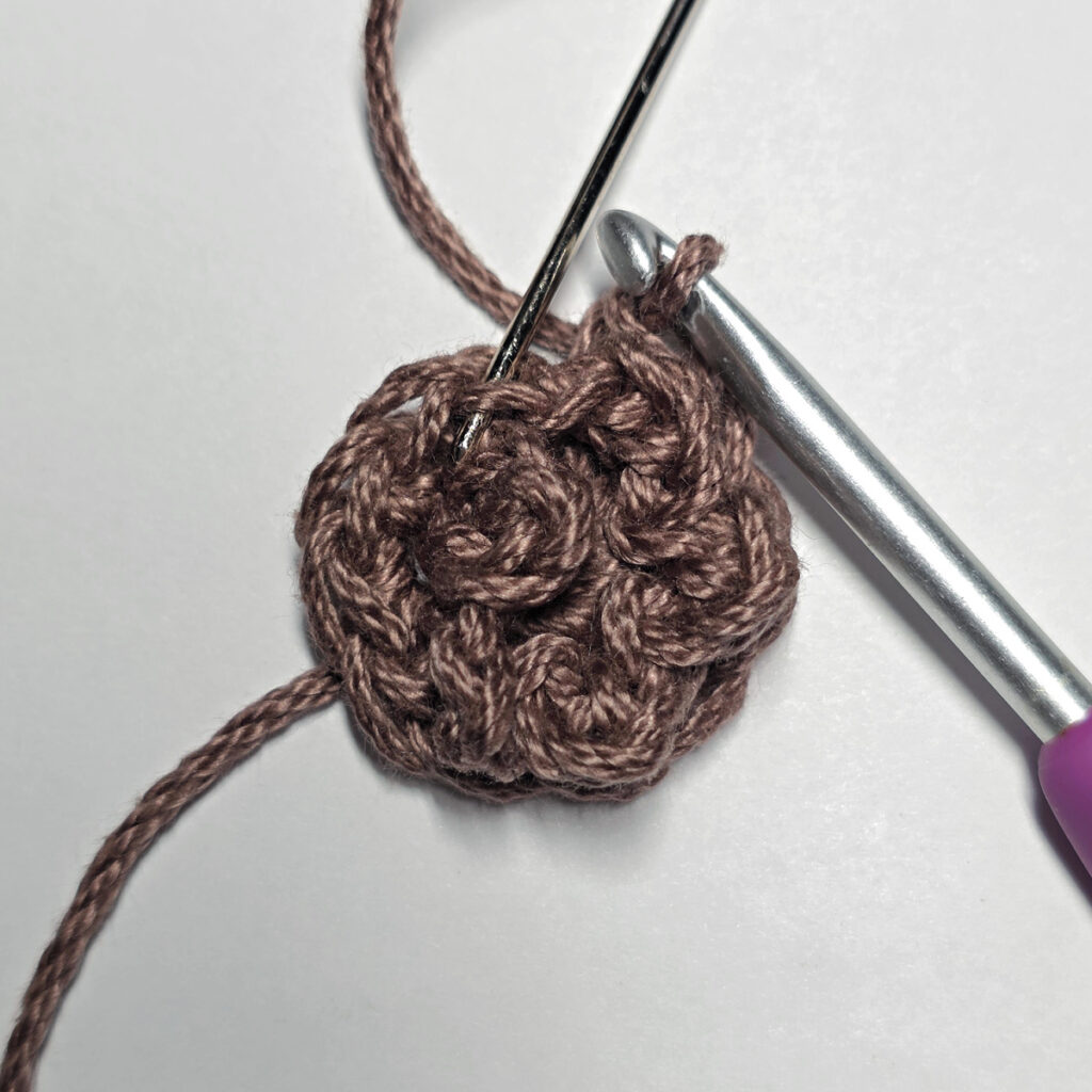 Making a crochet sunflower.