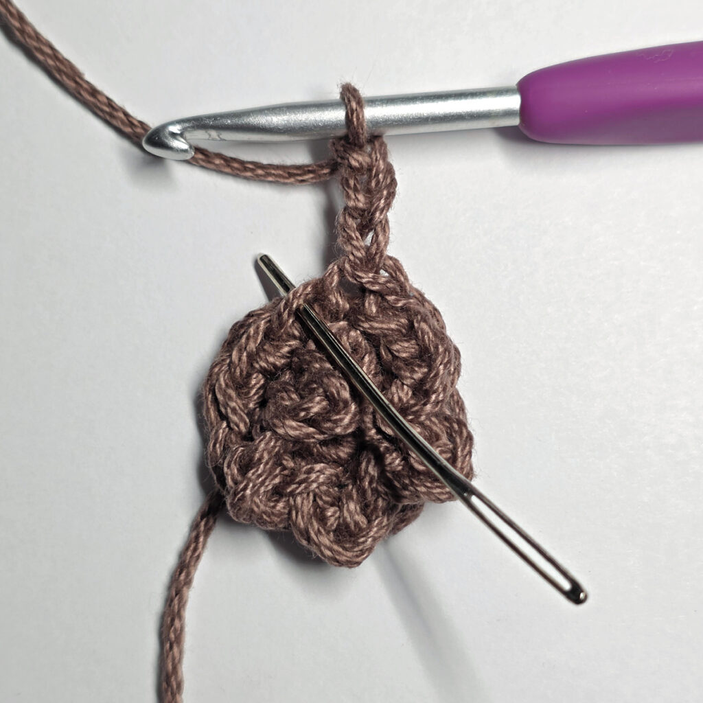 Making a crochet sunflower.