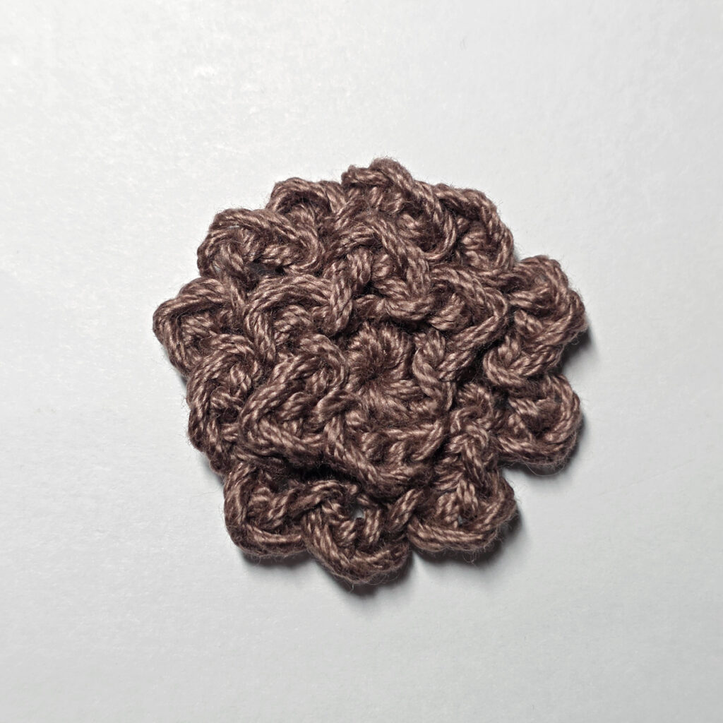 Making a crochet sunflower.