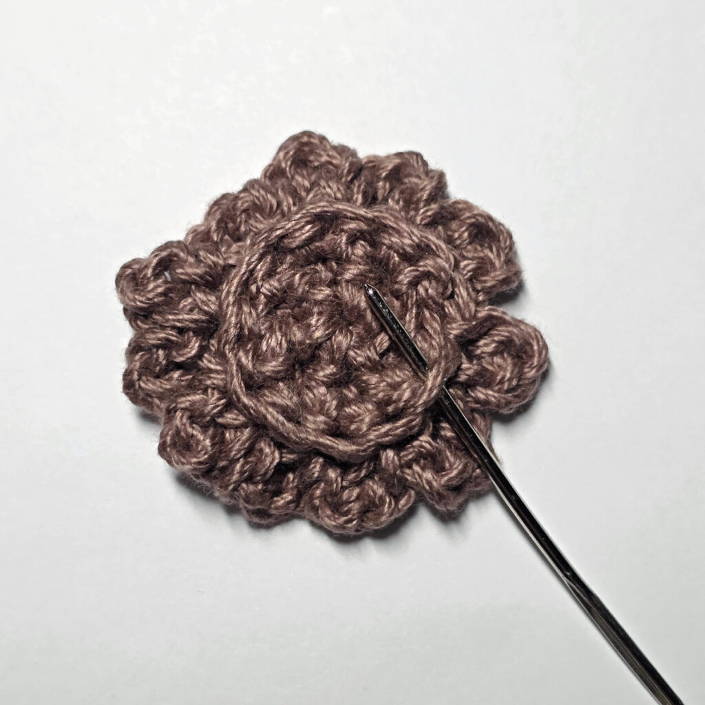 Making a crochet sunflower.