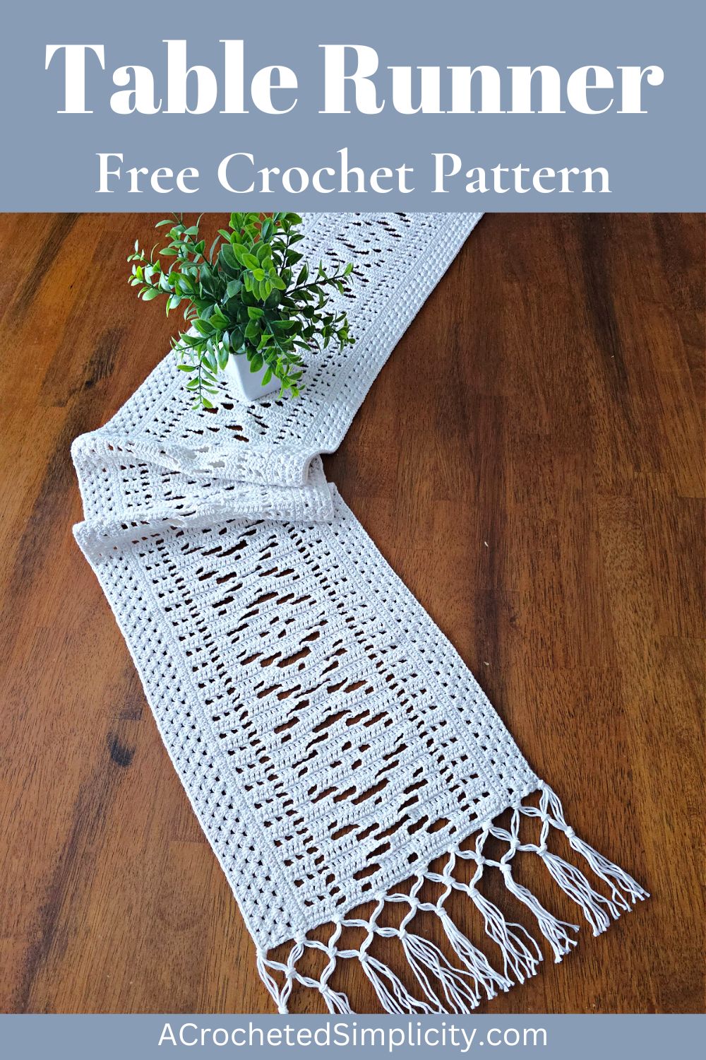 White lacy crochet table runner on a wooden table with a vase on top.
