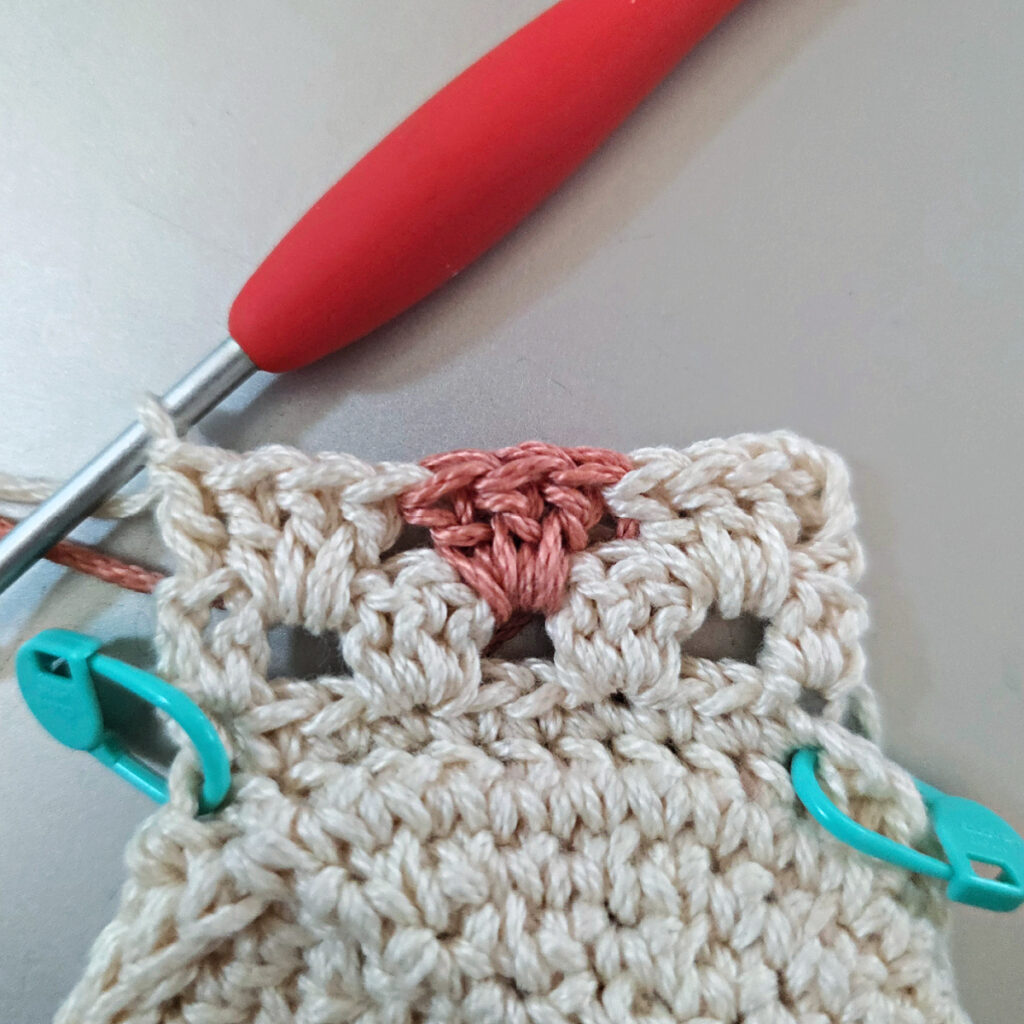 Making the colorful strap of a crossbody crochet bag.