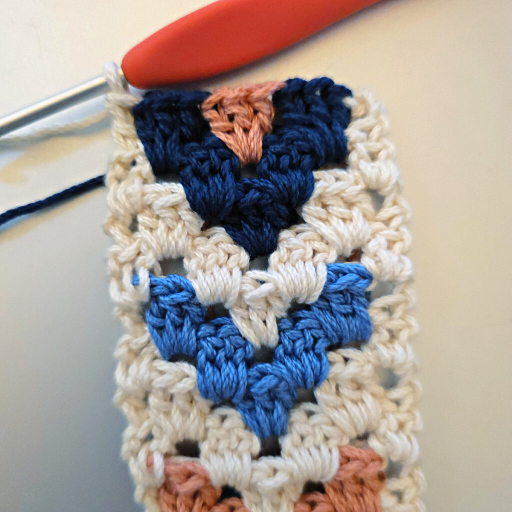 Making the colorful strap of a crossbody crochet bag.
