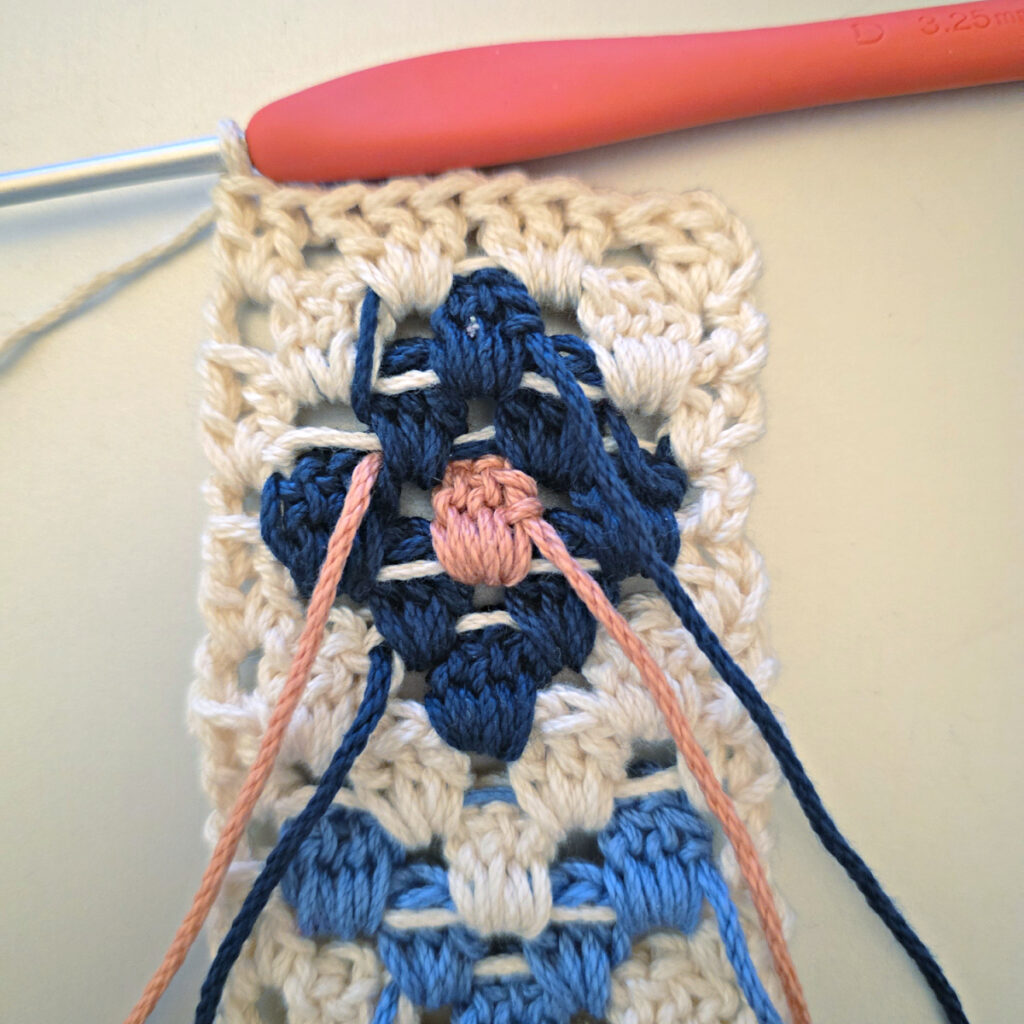 Making the colorful strap of a crossbody crochet bag.