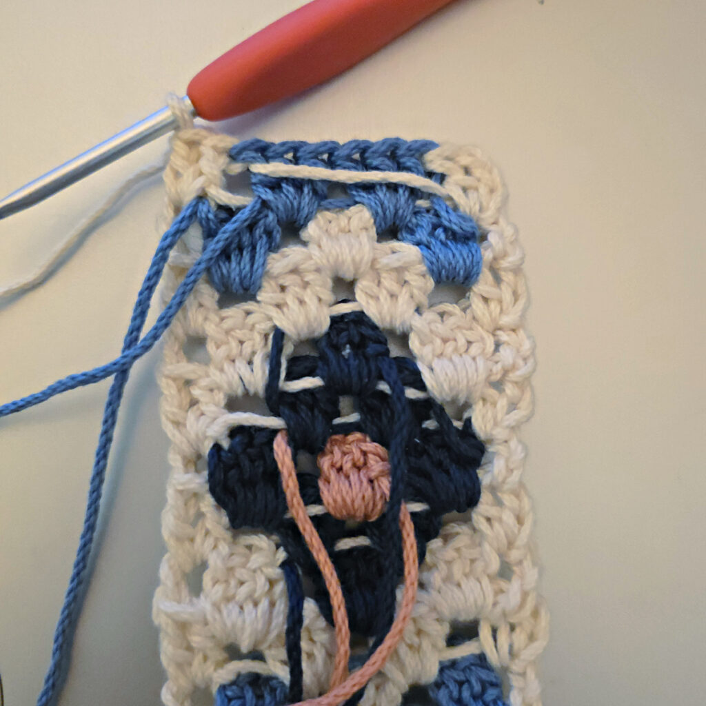 Making the colorful strap of a crossbody crochet bag.