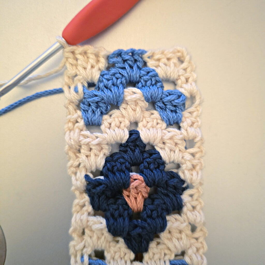 Making the colorful strap of a crossbody crochet bag.