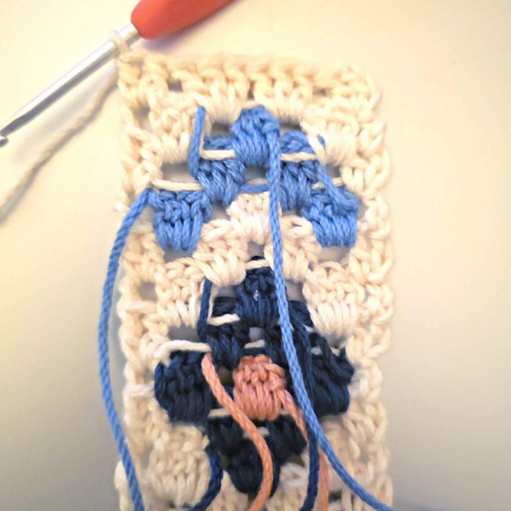 Making the colorful strap of a crossbody crochet bag.