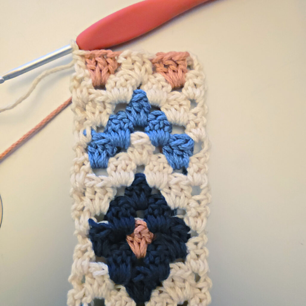Making the colorful strap of a crossbody crochet bag.