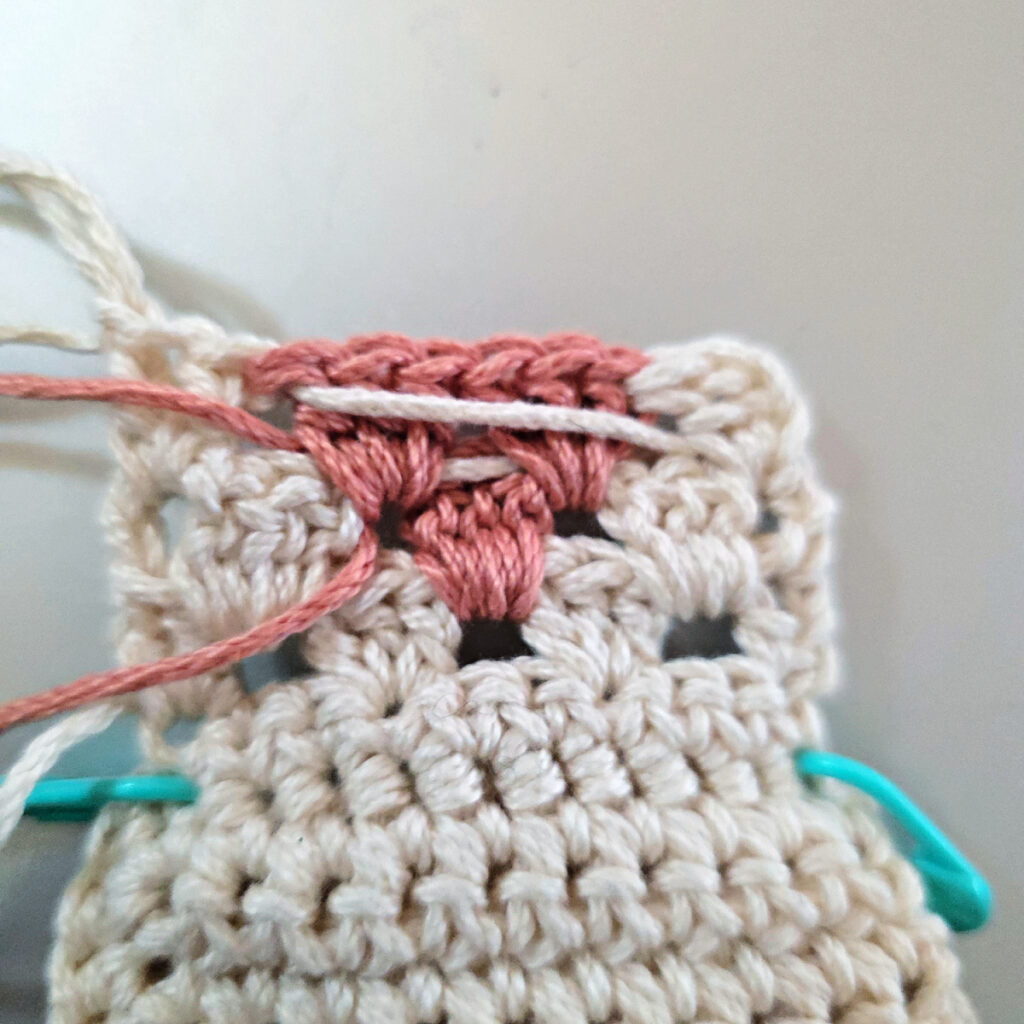 Making the colorful strap of a crossbody crochet bag.