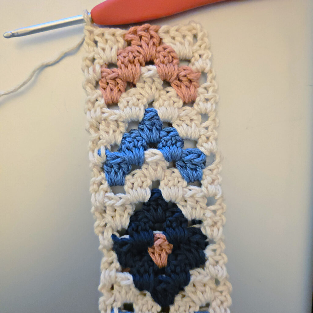 Making the colorful strap of a crossbody crochet bag.