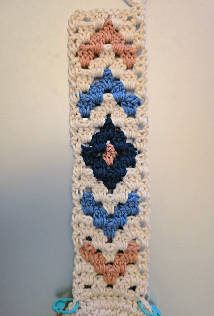 Making the colorful strap of a crossbody crochet bag.