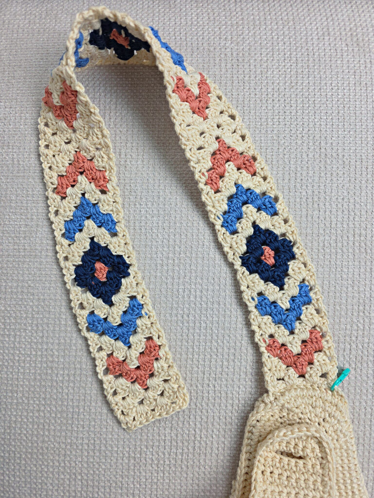 The finished colorful strap of a crochet crossbody bag.