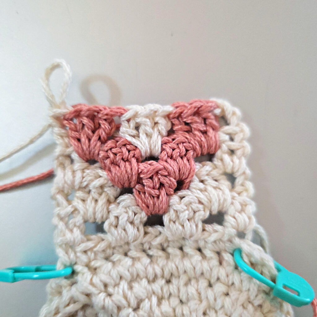 Making the colorful strap of a crossbody crochet bag.