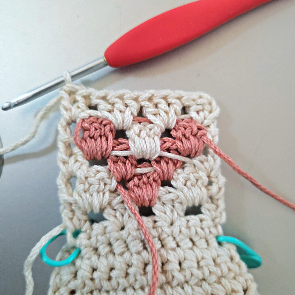 Making the colorful strap of a crossbody crochet bag.