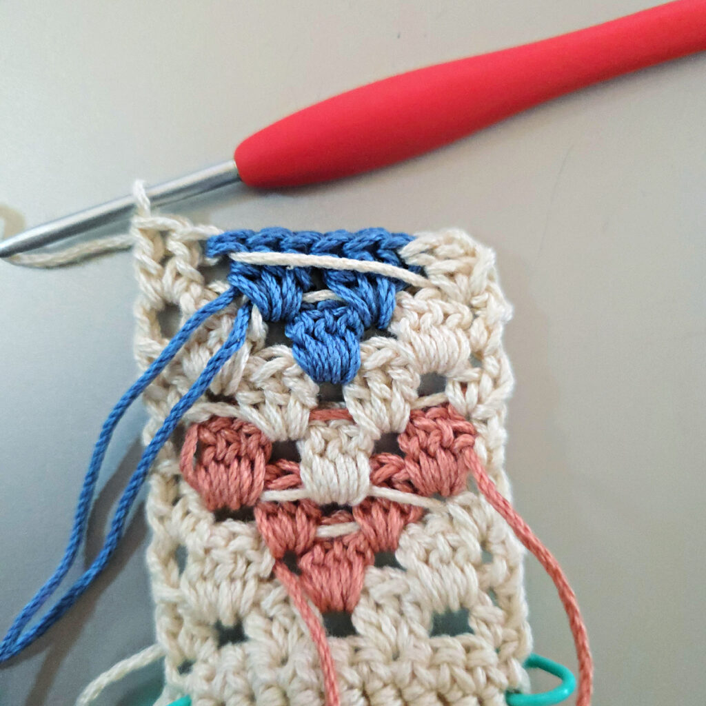 Making the colorful strap of a crossbody crochet bag.