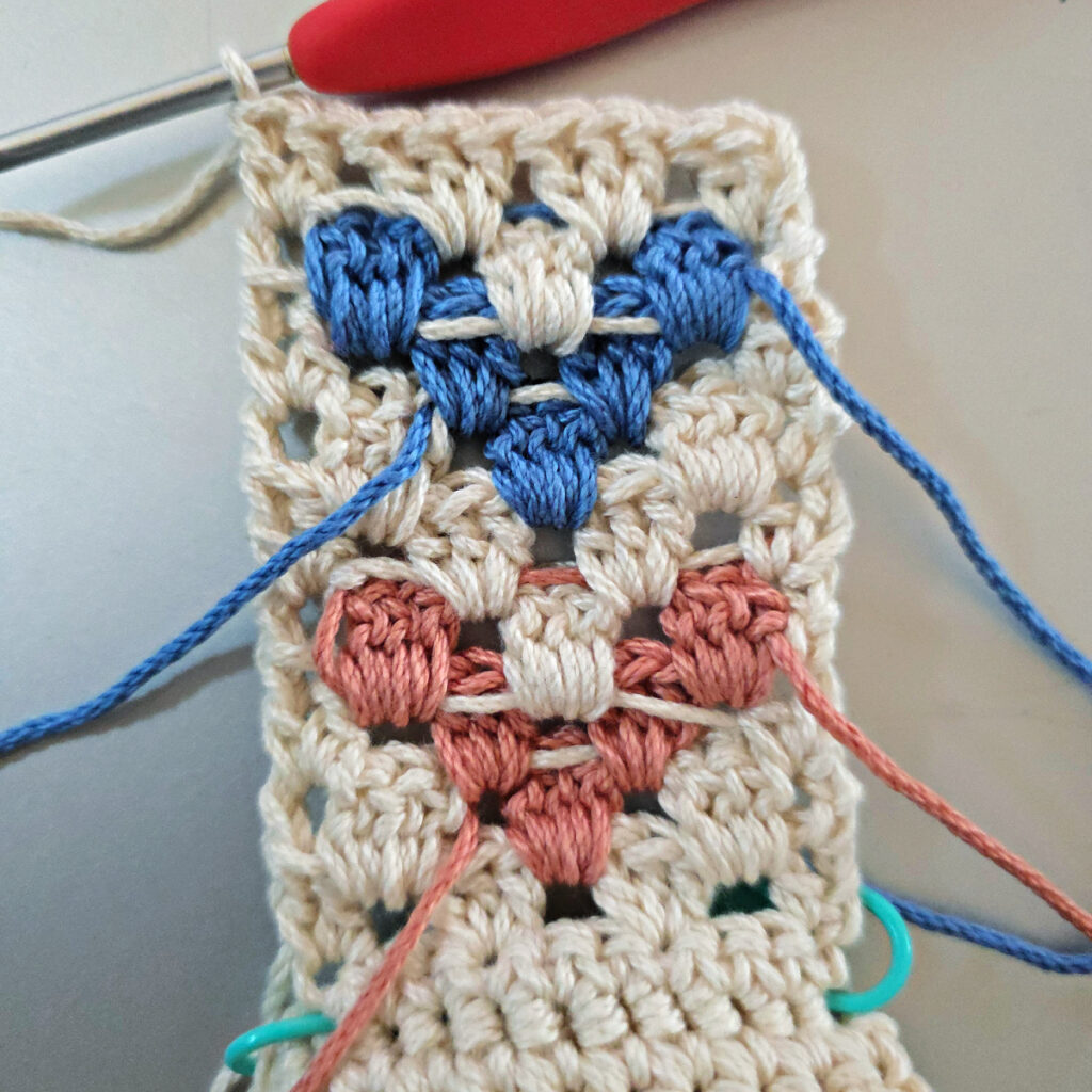 Making the colorful strap of a crossbody crochet bag.