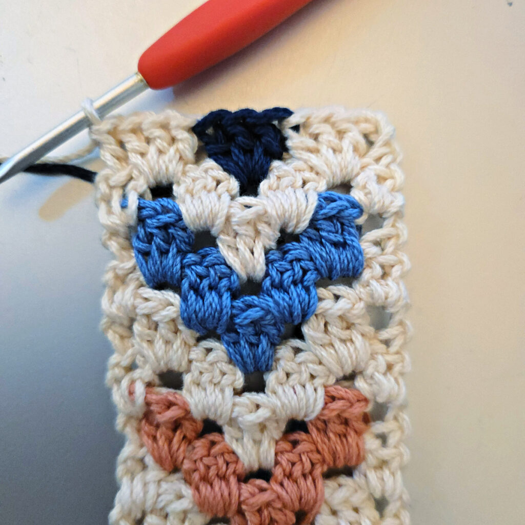 Making the colorful strap of a crossbody crochet bag.