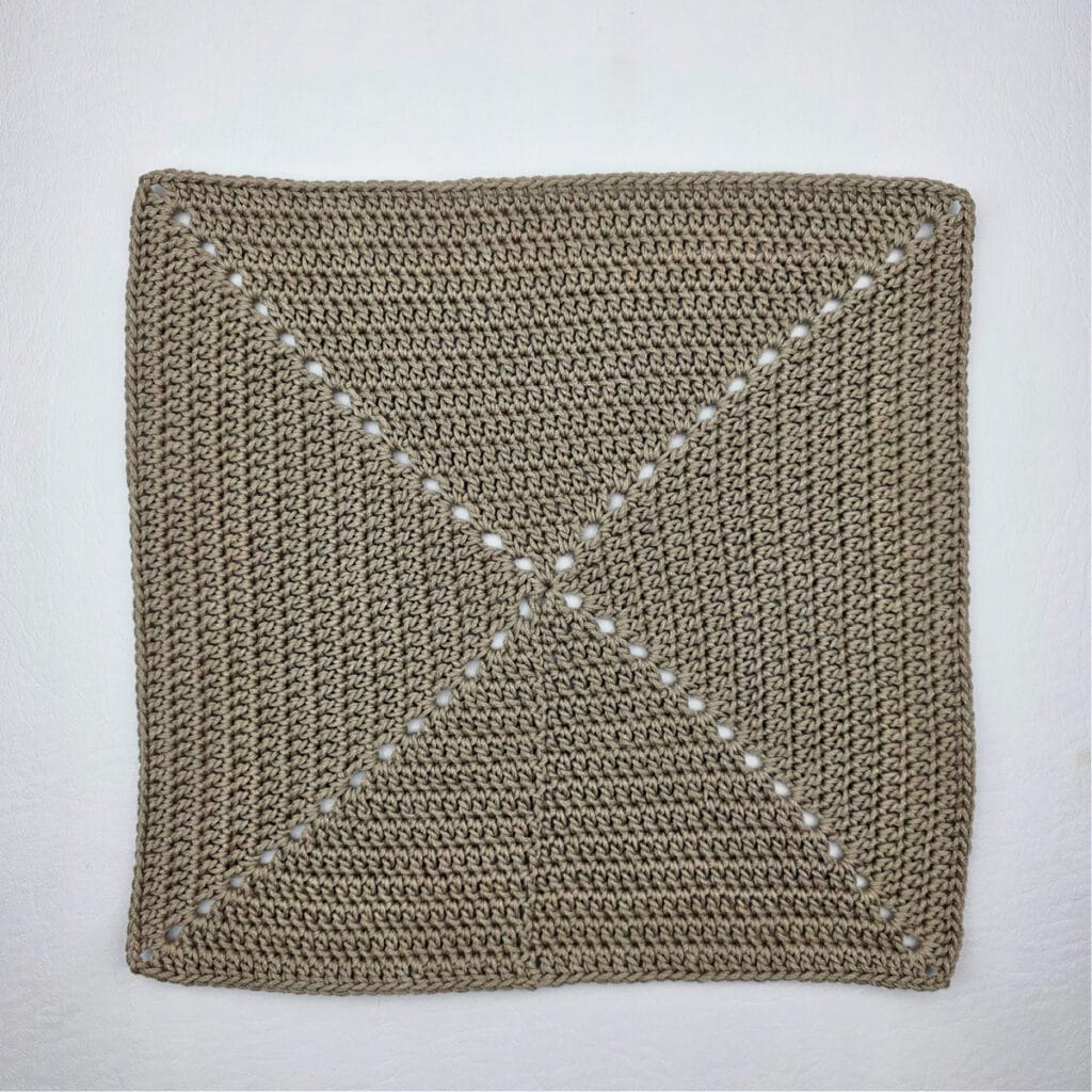 A large crochet square flat against a white background.