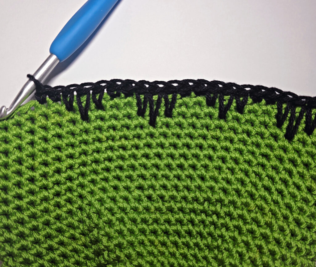 Making a crochet monster treat bag.