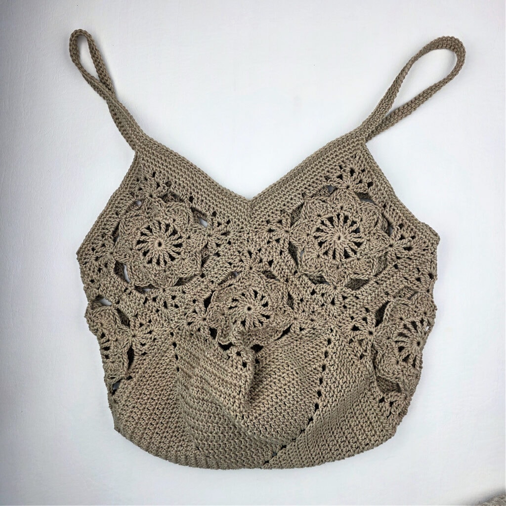 A crochet granny square bag against a white background.