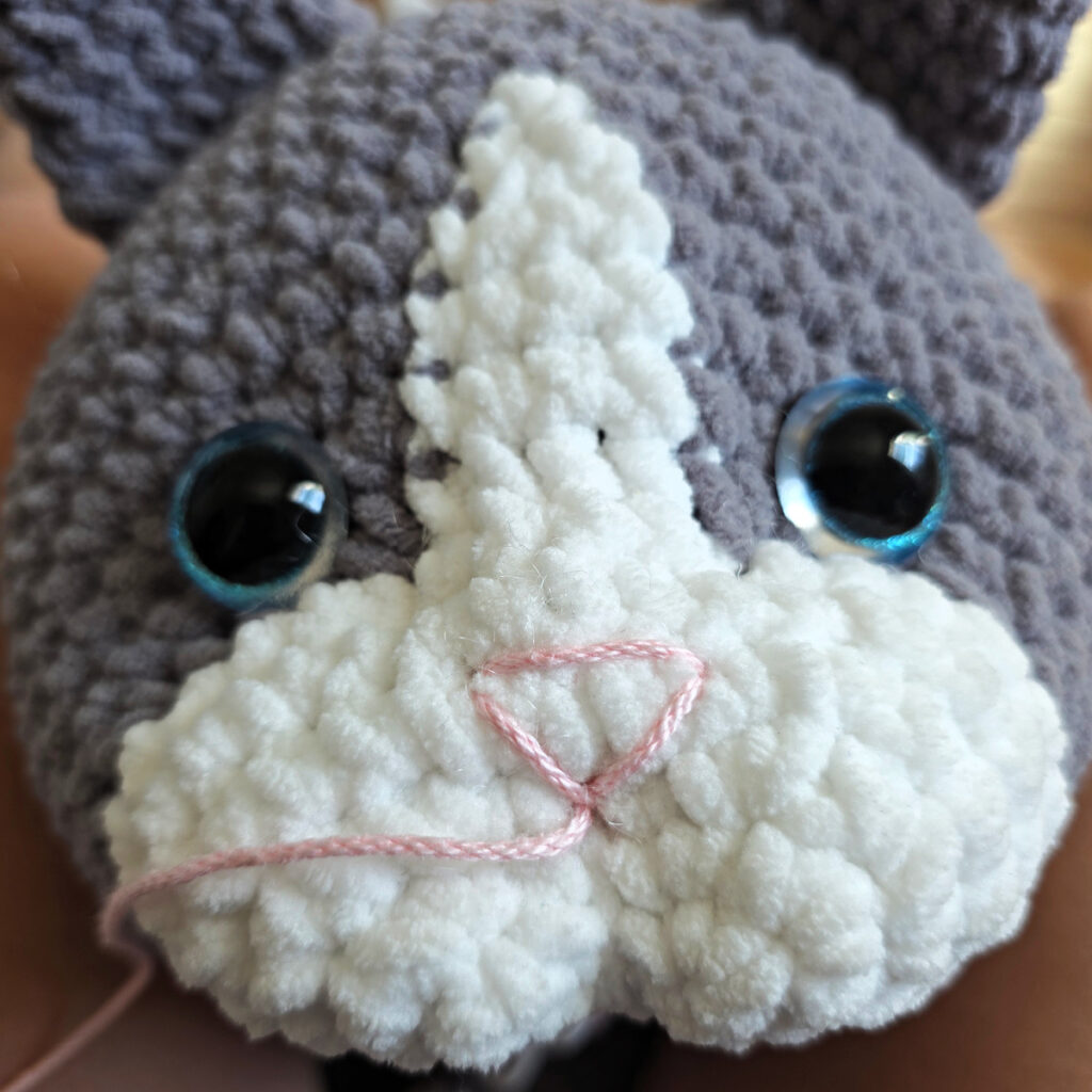 In process of assembling a crochet cat.
