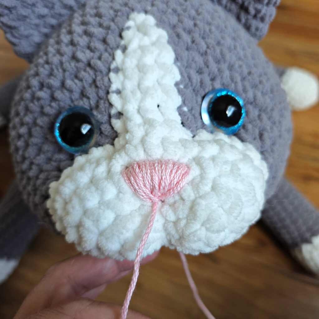 In process of assembling a crochet cat.
