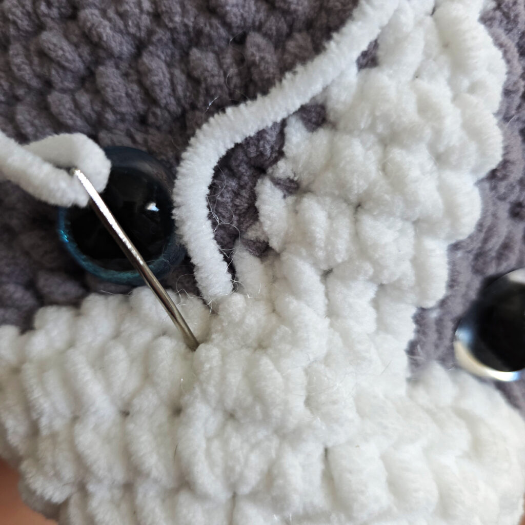 In process of assembling a crochet cat.