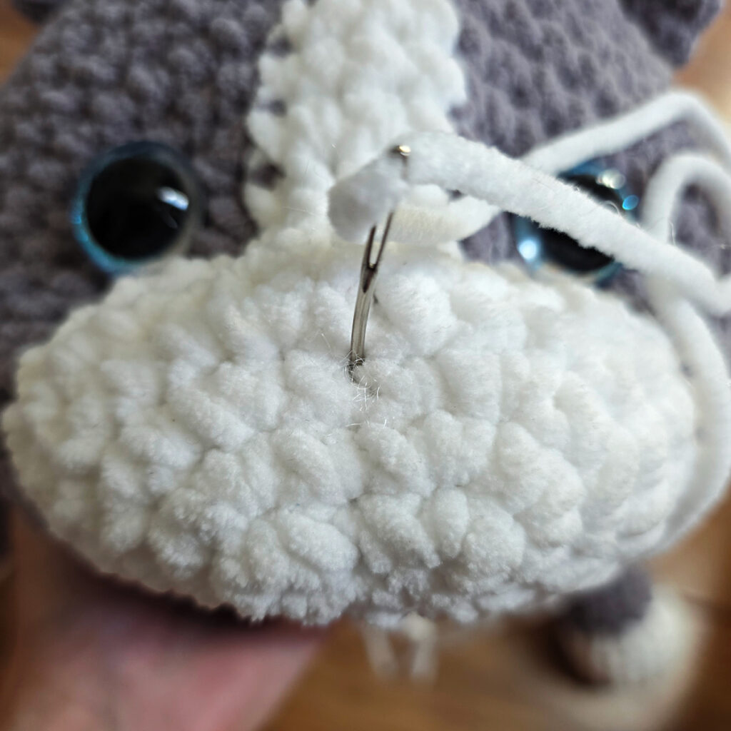 In process of assembling a crochet cat.