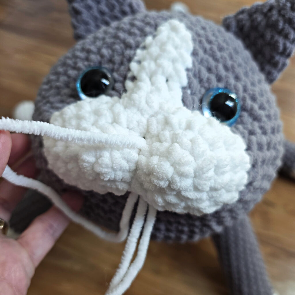 In process of assembling a crochet cat.