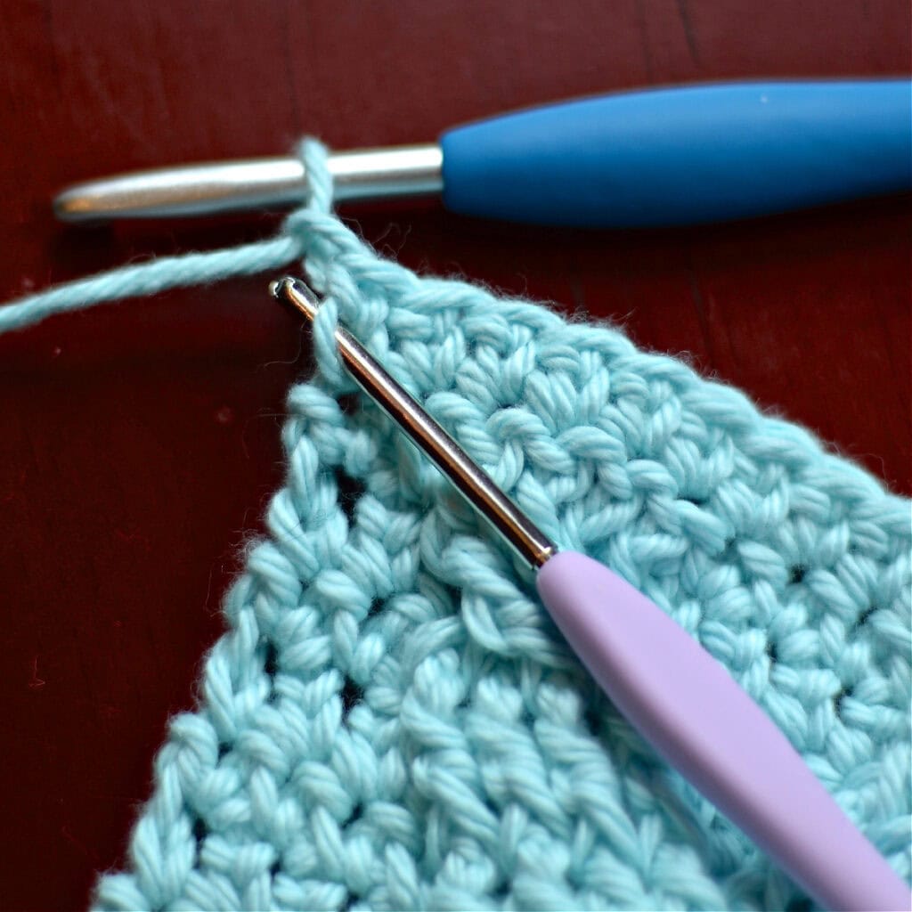 Making the border of a crochet blanket with two crochet hooks.