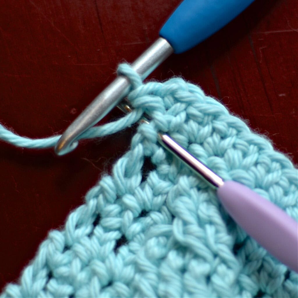Making the border of a crochet blanket with two crochet hooks.