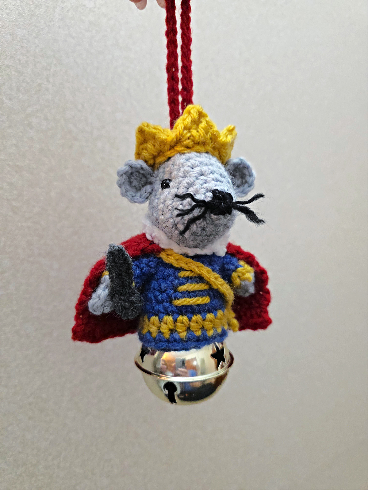 A close-up to show the details of a Mouse King crochet ornament.