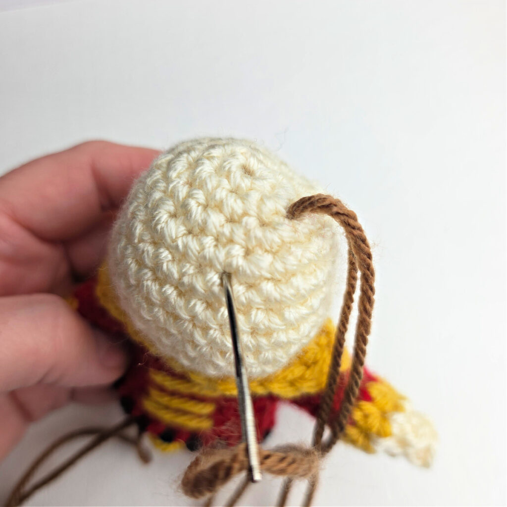 A tutorial showing how to add hair to a crocheted ornament.