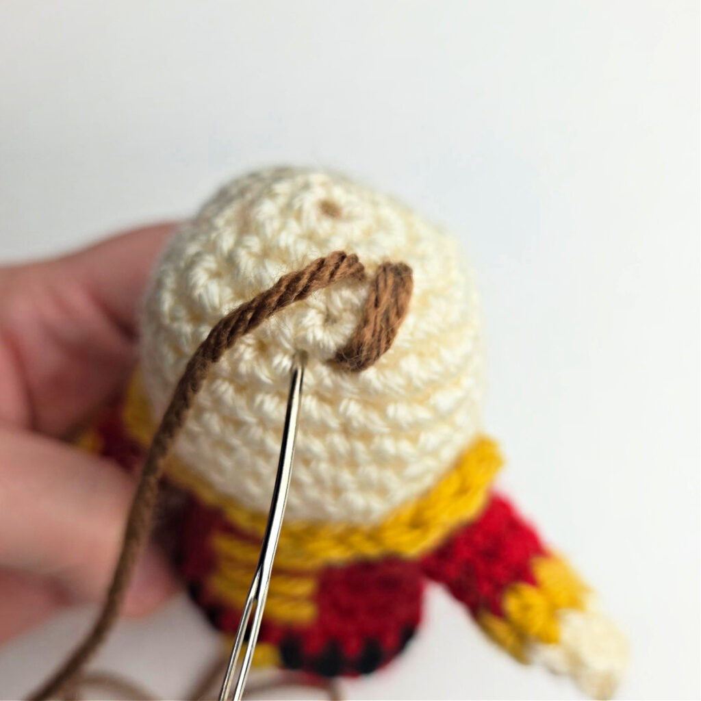 A tutorial showing how to add hair to a crocheted ornament.