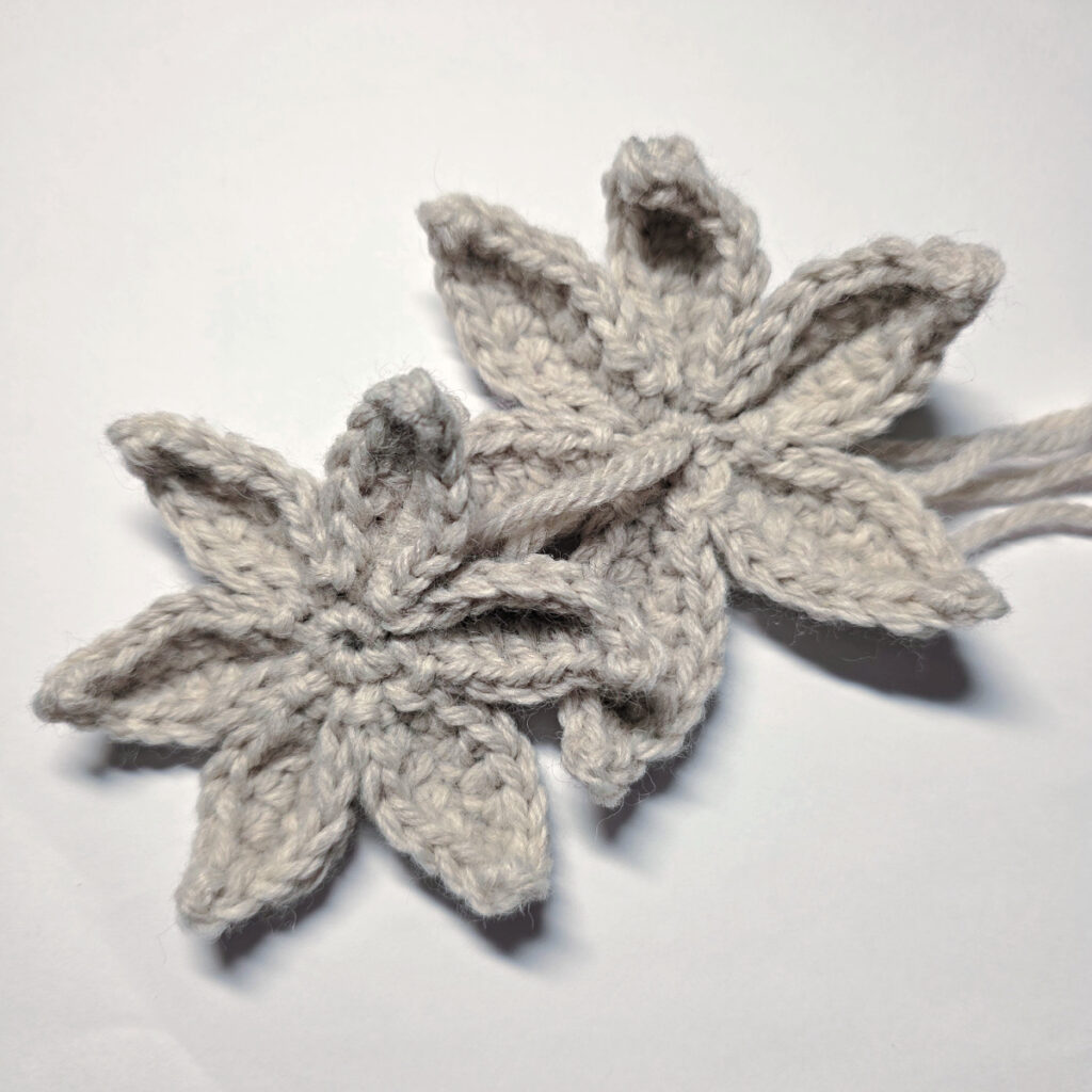 Two layers of the crochet poinsettia being joined.
