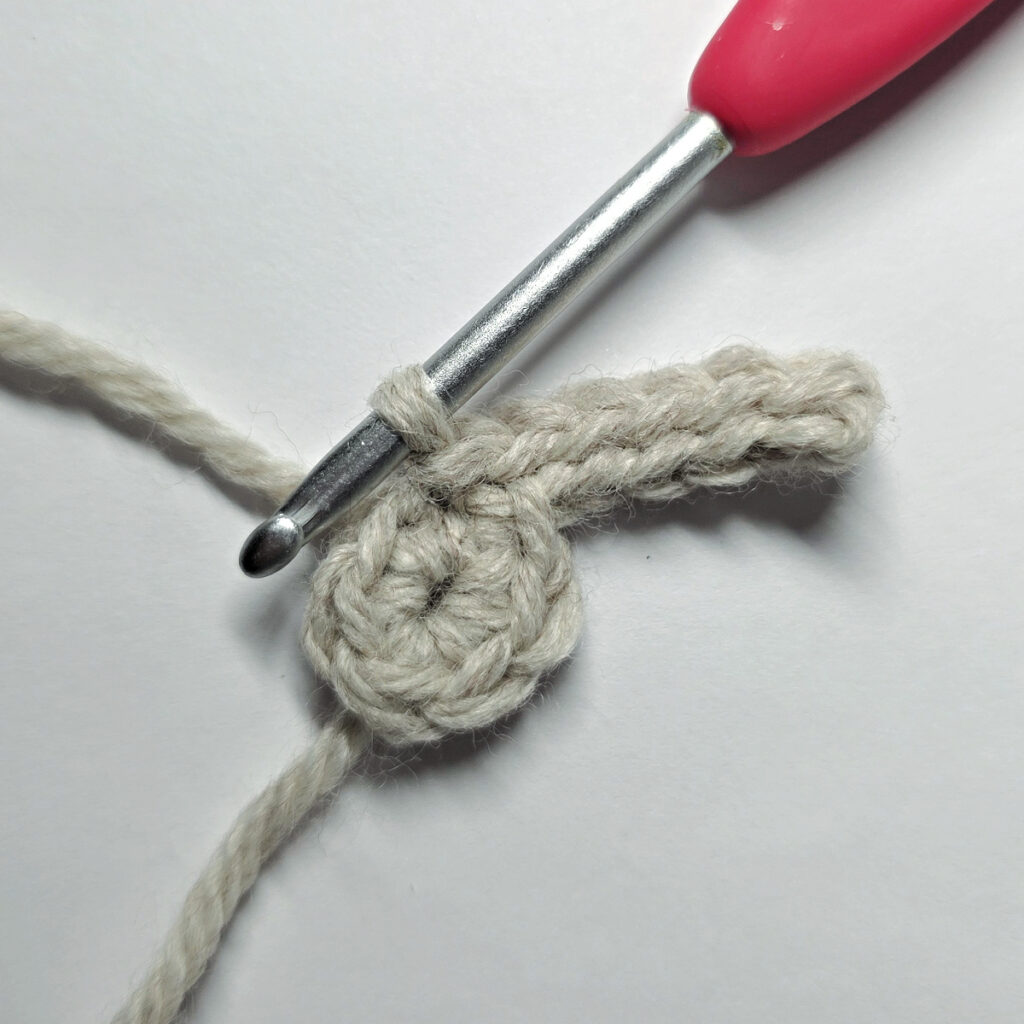 The beginning of round two of a crochet poinsettia to show the first flower vein.