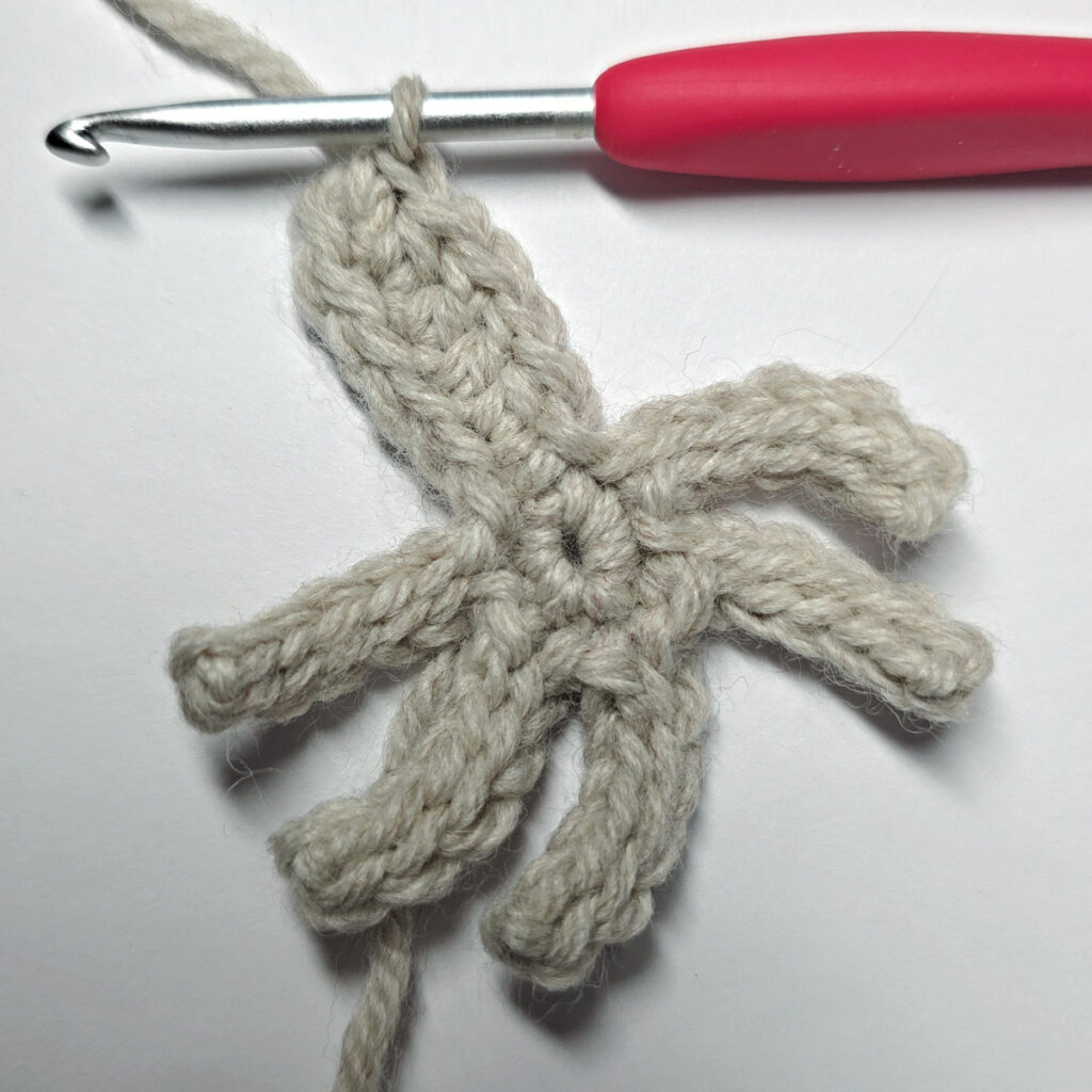 Round three of a crochet flower and the first petal being made.
