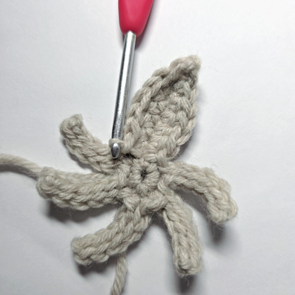 The first poinsettia bract crocheted in round 3.